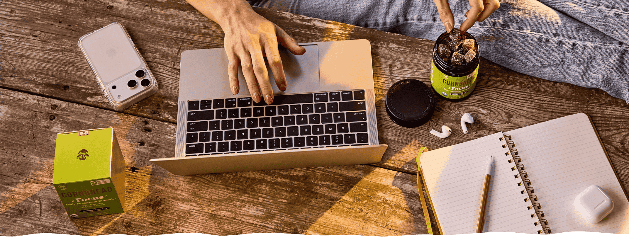 A person working on a laptop with Cornbread Hemp Mushroom Focus Gummies